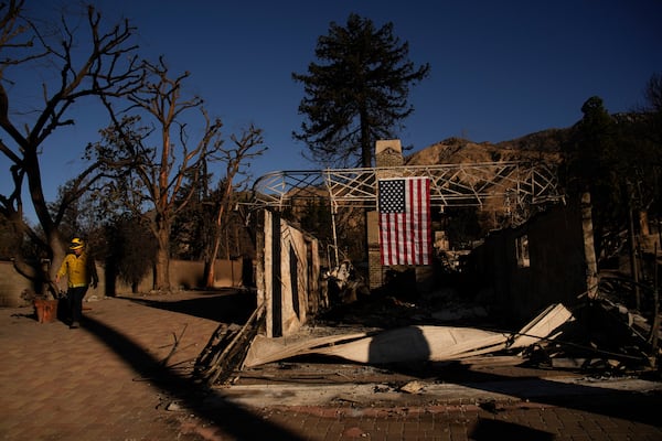 A firefighter inspect homes destroyed by the Eaton Fire in in Altadena, Calif., is seen Wednesday, Jan 15, 2025. (AP Photo/John Locher)