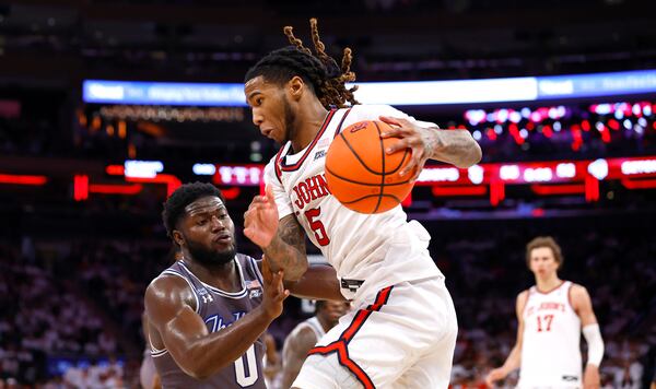 St. John's guard Deivon Smith (5) drives to the basket against Seton Hall guard Dylan Addae-Wusu (0) during the second half of an NCAA college basketball game, Saturday, March 1, 2025, in New York. (AP Photo/Noah K. Murray)