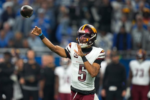 Washington Commanders quarterback Jayden Daniels (5) throws against the Detroit Lions during the first half of an NFL football divisional playoff game, Saturday, Jan. 18, 2025, in Detroit. (AP Photo/Seth Wenig)