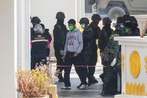 Thai soldiers provide security for the transfer of Indonesia nationals who had worked at scam centers in eastern Myanmar, on their arrival at Thailand's Mae Sot, Tak province before being sent back to Indonesia on Thursday, Feb. 27, 2025. (AP Photo/Sakchai Lalit)