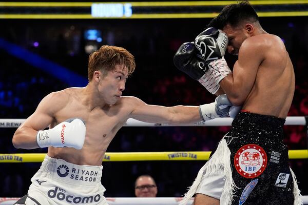 Naoya Inoue hits Ramon Cardenas in a junior featherweight title boxing match Sunday, May 4, 2025, in Las Vegas. (AP Photo/John Locher)