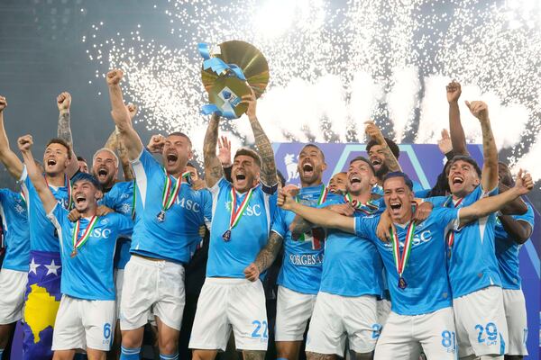 Napoli's team players celebrate during the awarding ceremony after winning the Italian league soccer title at the end of the Serie A soccer match between Napoli and Cagliari at the Diego Maradona stadium in Naples, Italy, Saturday, May 24, 2025. (AP Photo/Gregorio Borgia)