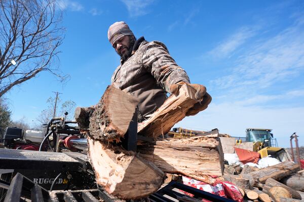 Sterling Howard splits logs for firewood ahead of a winter storm expected to hit the North Texas region later tomorrow Wednesday, Jan. 8, 2025, in Dallas. (AP Photo/LM Otero)