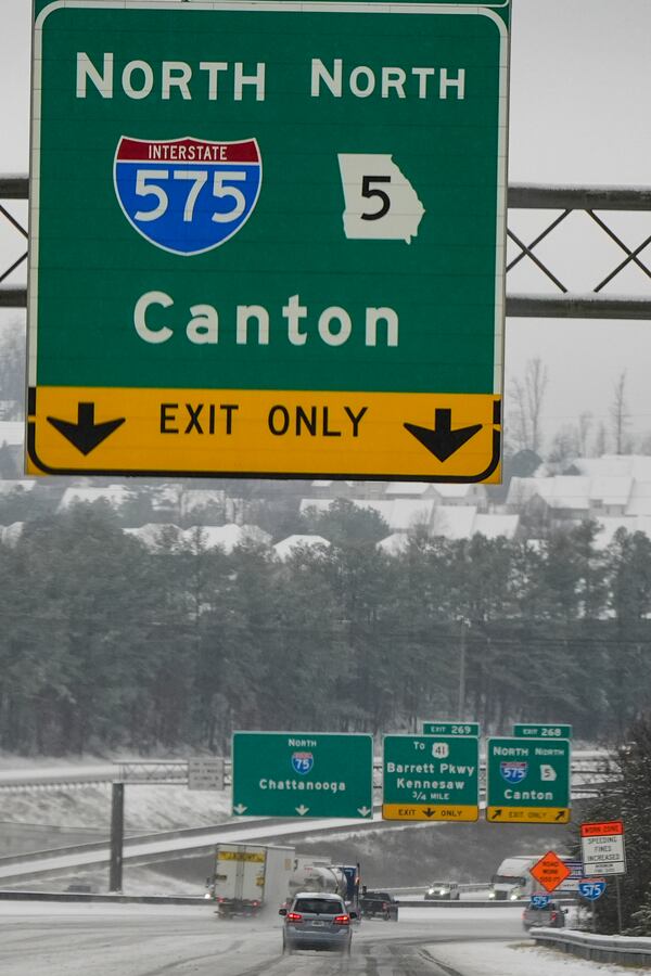 Vehicles move slowly on Interstate 75 during a winter storm, Friday, Jan. 10, 2025, in Kennesaw, Ga. (AP Photo/Mike Stewart)