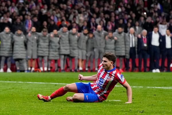 Atletico Madrid's Julian Alvarez falls to the ground after taking a penalty kick during a shootout at the end of the Champions League round of 16, second leg, soccer match between Atletico Madrid and Real Madrid at the Metropolitano stadium in Madrid, Spain, Wednesday, March 12, 2025. (AP Photo/Manu Fernandez)