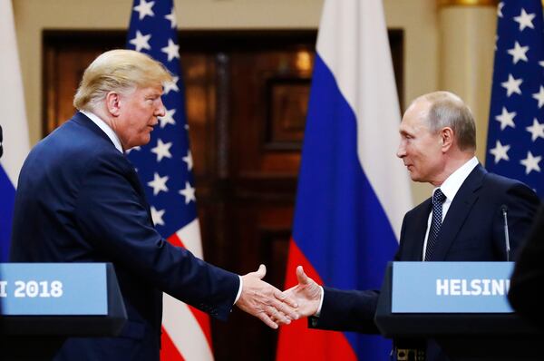 FILE - U.S. President Donald Trump shakes hands with Russian President Vladimir Putin at the end of a news conference at the Presidential Palace in Helsinki, Finland, on July 16, 2018. (AP Photo/Alexander Zemlianichenko, File)