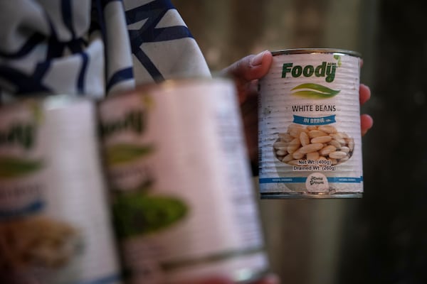 Wedad Abdelaal, whose 9-month-old son Khaled suffers from malnutrition, holds up a can of beans at her tent in a camp for displaced Palestinians in Mawasi Khan Younis, Gaza Strip, Friday, May 2, 2025." (AP Photo/Abdel Kareem Hana)