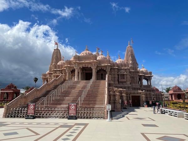 Visitors walk in front of the BAPS Shri Swaminarayan Mandir, the largest Hindu temple in California, on March 13, 2025. (AP Photo/Deepa Bharath)