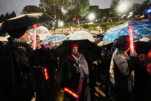 Israelis attend a rally against Prime Minister Benjamin Netanyahu's plan to dismiss the head of the Shin Bet internal security service, and calling for the release of hostages held by Hamas in the Gaza Strip, outside the Knesset, Israel's parliament in Jerusalem on Thursday, March 20, 2025. (AP Photo/Ohad Zwigenberg)