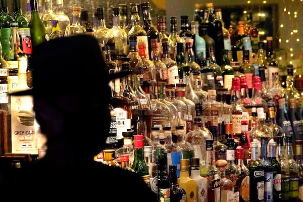 FILE - Bottles of alcohol sit on shelves at a bar in Houston, June 23, 2020. (AP Photo/David J. Phillip, File)