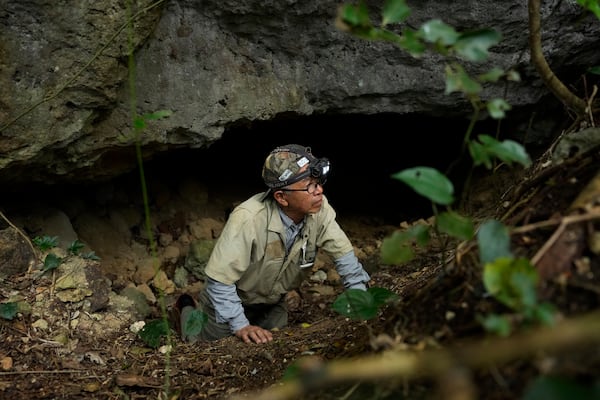 Takamatsu Gushiken leaves a cave after a session of searching for the remains of those who died during the Battle of Okinawa towards the end of the World War II in 1945, in Itoman, on the main island of the Okinawa archipelago, southern Japan, Saturday, Feb. 15, 2025. (AP Photo/Hiro Komae)