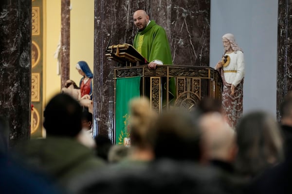 Priest Homero Sanchez speaks during a service at St. Rita of Cascia Parish in Chicago, Sunday, Jan. 19, 2025. (AP Photo/Nam Y. Huh)