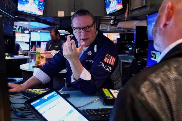 Specialist Gregg Maloney, left, works on the floor of the New York Stock Exchange, Wednesday, May 7, 2025. (AP Photo/Richard Drew)