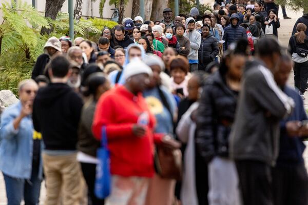 People impacted by the Eaton Fire wait in line to access Pasadena City College's gymnasium, where The Change Reaction will be handing out about 1,000 checks of between $2,500-$5,000, Tuesday, Jan. 28, 2025 in Pasadena, Calif. (AP Photo/Etienne Laurent)