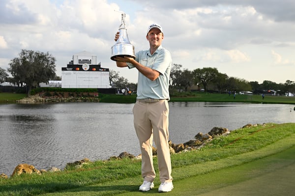 Russell Henley holds the championship trophy after winning the Arnold Palmer Invitational at Bay Hill golf tournament, Sunday, March 9, 2025, in Orlando, Fla. (AP Photo/Phelan M. Ebenhack)