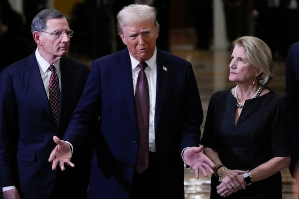 President-elect Donald Trump, flanked by Sen. John Barrasso, R-Wyo., left, and Sen. Shelley Moore Capito, R-W.Va., talks to reporters after a meeting with Republican leadership at the Capitol on Wednesday, Jan. 8, 2025, in Washington. (AP Photo/Steve Helber)