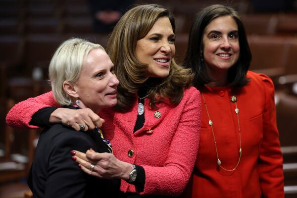 From left, Rep. Victoria Spartz, R-Ind., House Republican Conference Chair Lisa McClain, R-Mich., and Rep. Nicole Malliotakis, R-N.Y., embrace as they talk on the floor before President Donald Trump addresses a joint session of Congress at the Capitol in Washington, Tuesday, March 4, 2025. (Win McNamee/Pool Photo via AP)