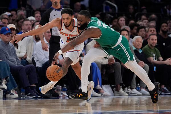 New York Knicks' Cameron Payne, left, and Boston Celtics' Jaylen Brown, right, battle for the ball during the first half of Game 3 of an NBA basketball second-round playoff series, Saturday, May 10, 2025, in New York. (AP Photo/Pamela Smith)