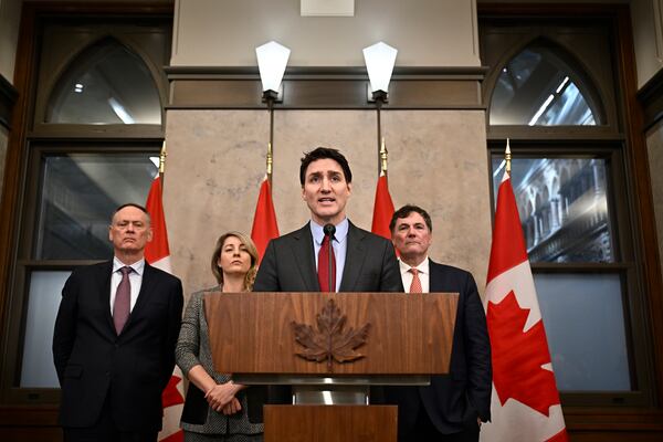 Prime Minister Justin Trudeau addresses media following the imposition of a raft of tariffs by U.S. President Donald Trump against Canada, Mexico and China, in Ottawa, Saturday, Feb. 1, 2025. Minister of Public Safety David McGuinty, left to right, Global Affairs Minister Melanie Joly and Minister of Governmental Affairs Dominic LeBlanc look on. (Justin Tang/The Canadian Press via AP)