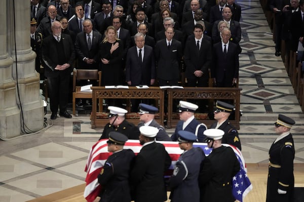 The flag-draped casket of former President Jimmy Carter departs after a state funeral at Washington National Cathedral in Washington, Thursday, Jan. 9, 2025. (AP Photo/Ben Curtis)