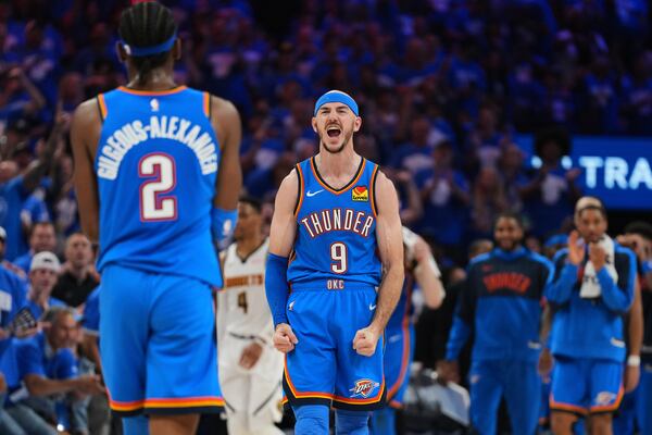 Oklahoma City Thunder's Shai Gilgeous-Alexander (2), Alex Caruso (9) and the bench celebrate late in the second half of Game 7 in the Western Conference semifinals of the NBA basketball playoffs against the Denver Nuggets, Sunday, May 18, 2025, in Oklahoma City. (AP Photo/Kyle Phillips)