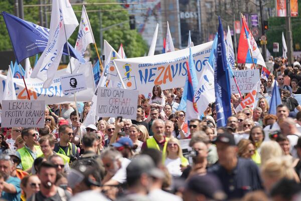 University students and people protest in front of the government building, six months after the deadly train station tragedy that sparked mass demonstrations against corruption, in Belgrade, Serbia, Thursday, May 1, 2025. (AP Photo/Darko Vojinovic)
