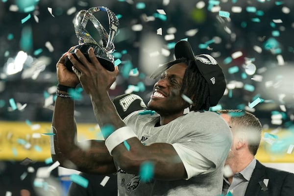 Philadelphia Eagles wide receiver A.J. Brown celebrates with the trophy after their win against the Washington Commanders in the NFC Championship NFL football game, Sunday, Jan. 26, 2025, in Philadelphia. (AP Photo/Seth Wenig)