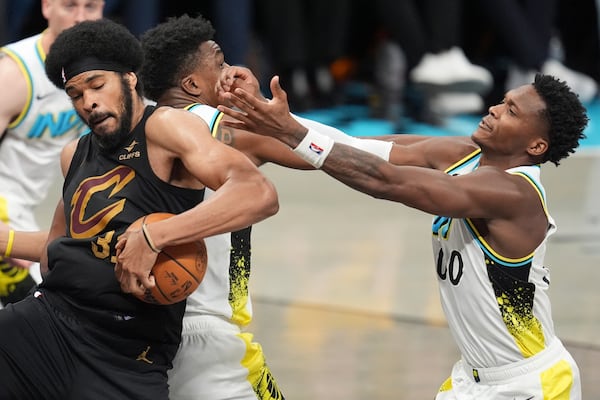Cleveland Cavaliers center Jarrett Allen (31) takes the ball from Indiana Pacers center Thomas Bryant, second from left, and guard Bennedict Mathurin (00) during the second half of Game 3 in the Eastern Conference semifinals of the NBA basketball playoffs in Indianapolis, Friday, May 9, 2025. (AP Photo/Michael Conroy)