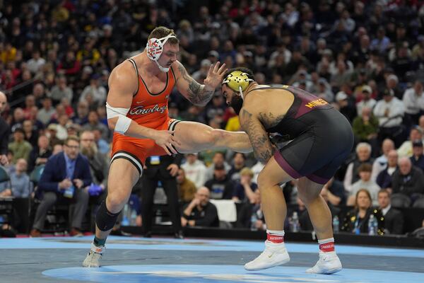 FILE - Oklahoma State's Wyatt Hendrickson, left, takes on Minnesota's Gable Steveson during a 285-pound match in the finals at the NCAA wrestling championship, Saturday, March 22, 2025, in Philadelphia. (AP Photo/Matt Rourke, File)