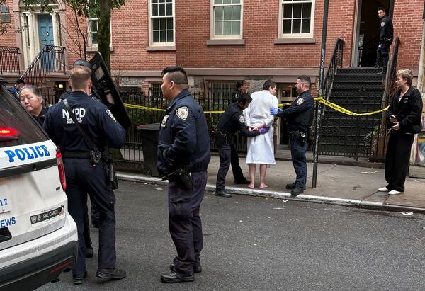New York police officers arrest John Woeltz, Friday, May 23, 2025, in New York, who was charged with kidnapping, assaulting and holding a man against his will for several weeks in an upscale Manhattan town house.(AP Photo/Kava Gorna via AP)