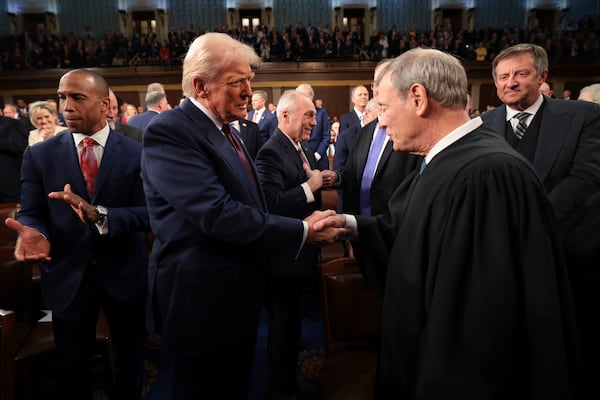 President Donald Trump, center, greets Chief Justice of the Supreme Court John Roberts, right, as he arrives to address a joint session of Congress at the Capitol in Washington, Tuesday, March 4, 2025. (Win McNamee/Pool Photo via AP)