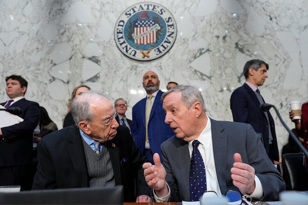 Senate Judiciary Committee Chairman Chuck Grassley, R- Iowa, left, confers with Sen. Dick Durbin, D-Ill., the ranking member, as the panel meets to advance Trump nominees, on Capitol Hill in Washington, Thursday, Feb. 20, 2025. (AP Photo/J. Scott Applewhite)