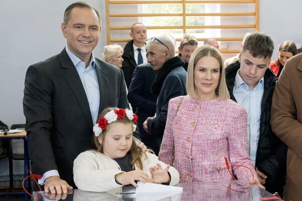 Karol Nawrocki, left, a non-partisan Presidential candidate supported by the right wing Law and Justice Party casting his vote with his family; wife Marta Nawrocka, center, and daughter Katarzyna, son Antonii , right, during the presidential election in Gdansk, Poland on Sunday, May 18, 2025. (AP Photo/Wojciech Strozyk)