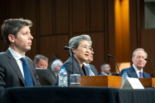 Dr. Lisa Su, chief executive officer and chair, Advanced Micro Devices (AMD), center, testifies before a Senate Committee on Commerce, Science, and Transportation hearing with Sam Altman, co-founder and chief executive officer, OpenAI, left, and Brad Smith, vice chair and president, Microsoft Corporation, right, Thursday, May 8, 2025, in Washington. (AP Photo/Kevin Wolf)