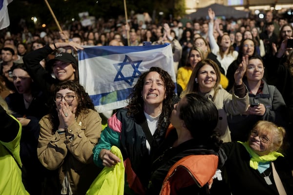 Relatives and friends of people killed and abducted by Hamas and taken into Gaza, react to the news of the hostages' release, as they gather in Tel Aviv, Israel on Sunday, Jan. 19, 2025. (AP Photo/Oded Balilty)