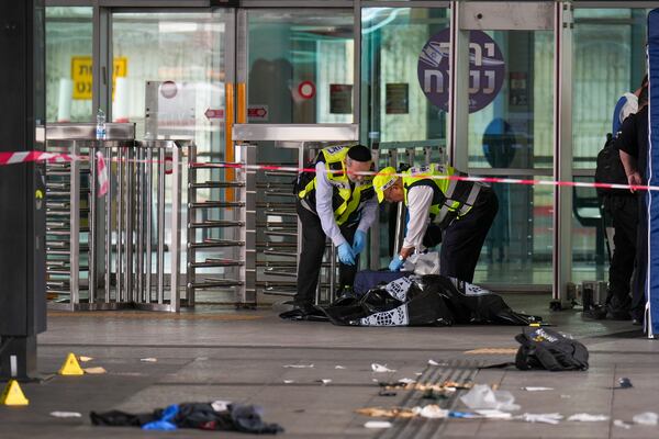 Israeli rescue and security forces examine the scene of a stabbing attack in Haifa, Israel, on Monday, March 30, 2025, where a 70-year-old man was killed and four others were injured. (AP Photo/Ariel Schalit)