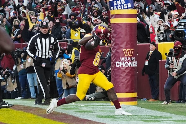 Washington Commanders wide receiver Jamison Crowder (80) scoring a touchdown against the Philadelphia Eagles during the second half of an NFL football game, Sunday, Dec. 22, 2024, in Landover, Md. (AP Photo/Stephanie Scarbrough)