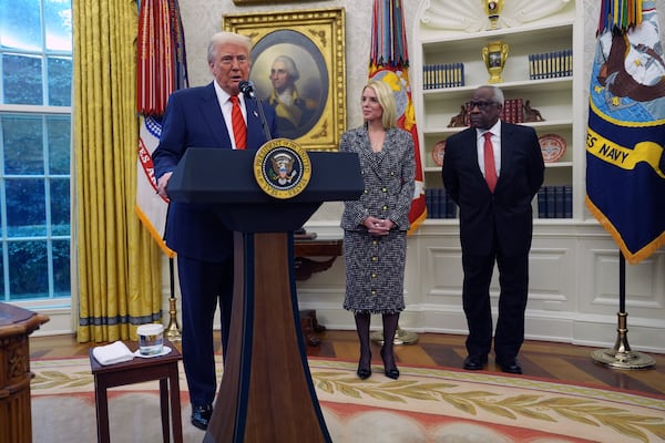 President Donald Trump welcomes Pam Bondi before she is sworn in as Attorney General by Supreme Court Associate Justice Clarence Thomas, right, in the Oval Office of the White House, Wednesday, Feb. 5, 2025, in Washington. (AP Photo/Evan Vucci)