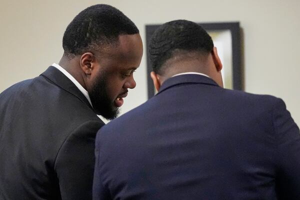 Former Memphis Police Officer Tedarrius Bean, left, one of three former Memphis officers charged with fatally beating Tyre Nichols in 2023, speaks to his attorney during his trial, Wednesday, April 30, 2025, in Memphis, Tenn. (AP Photo/George Walker IV, Pool)