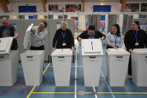 The election commission prepares ballot boxes for people to cast their vote in parliamentary elections, in Nuuk, Greenland, Tuesday, March 11, 2025. (AP Photo/Evgeniy Maloletka)