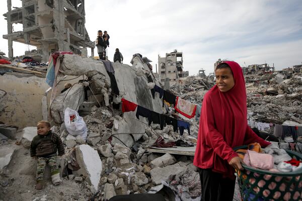 Members of Nijim family hang laundry on the ruins of their house, amid widespread destruction caused by the Israeli military's ground and air offensive in Jabaliya, Gaza Strip, on Tuesday, Feb. 18, 2025. (AP Photo/Jehad Alshrafi)