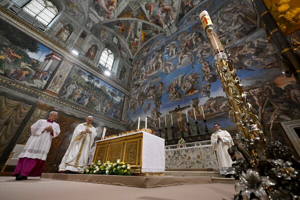 Newly elected Pope Leo XIV, second from left, concelebrates Mass with the College of Cardinals inside the Sistine Chapel at the Vatican the day after his election as 267th pontiff of the Roman Catholic Church, Friday, May 9, 2025. (Vatican Media via AP)