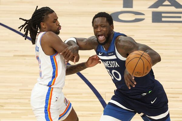 Minnesota Timberwolves forward Julius Randle (30) loses control of the ball while defended by Oklahoma City Thunder guard Cason Wallace (22) during the first half of Game 3 of the Western Conference finals of the NBA basketball playoffs, Saturday, May 24, 2025, in Minneapolis. (AP Photo/Matt Krohn)