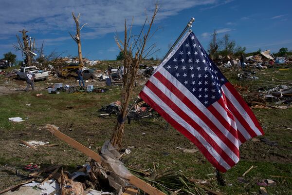 An American Flag is posted near destroyed homes, Sunday, May 18, 2025, in London, Ky., after a severe storm passed through the area. (AP Photo/Carolyn Kaster)