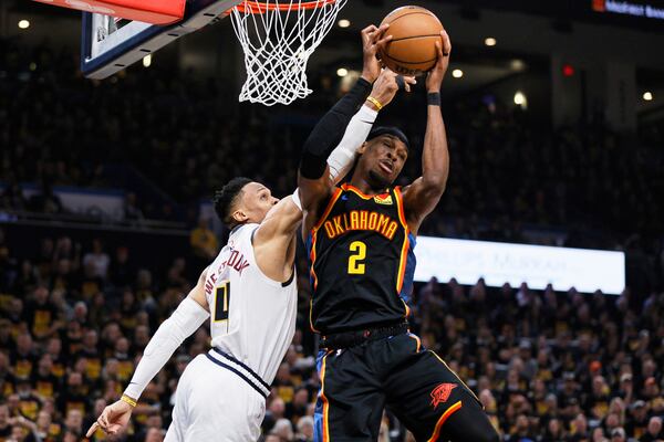 Oklahoma City Thunder guard Shai Gilgeous-Alexander (2) comes down with a rebound in front of Denver Nuggets' Russell Westbrook, left, in the first half of Game 1 of an NBA basketball second-round playoff series Monday, May 5, 2025, in Oklahoma City. (AP Photo/Nate Billings)