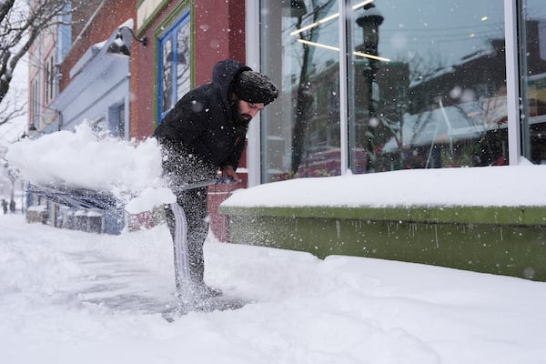 FILE - Jagmeet Singh, a manager at Clifton Market, shovels the sidewalk in front of the store during a winter storm, Jan. 6, 2025, in Cincinnati. (AP Photo/Joshua A. Bickel, FIle)