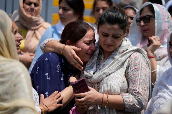 Relatives mourn at the funeral of Raj Thapa, a senior bureaucrat who was killed in Pakistani shelling in Rajouri, in Jammu, India, Sunday, May 11, 2025. (AP Photo/Channi Anand)