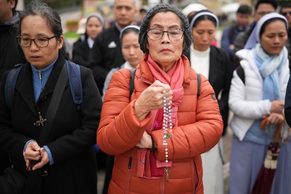 Vietnamese faithful pray at Agostino Gemelli Polyclinic, in Rome, Tuesday, Feb. 25, 2025 where Pope Francis is hospitalized since Friday, Feb. 14. (AP Photo/Alessandra Tarantino)