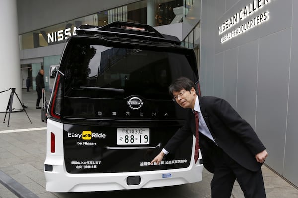 Takeshi Kimura, a Nissan engineer overseeing the Japanese automaker’s self-driving technology, shows the car packed with the technology to reporters at Nissan headquarters in Yokohama, near Tokyo, on March 6, 2025. (AP Photo/Yuri Kageyama)