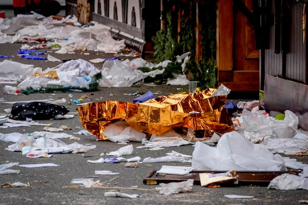 A blanket lies on a Christmas Market, where a car drove into a crowd on Friday evening, in Magdeburg, Germany, Saturday, Dec. 21, 2024. (AP Photo/Michael Probst)